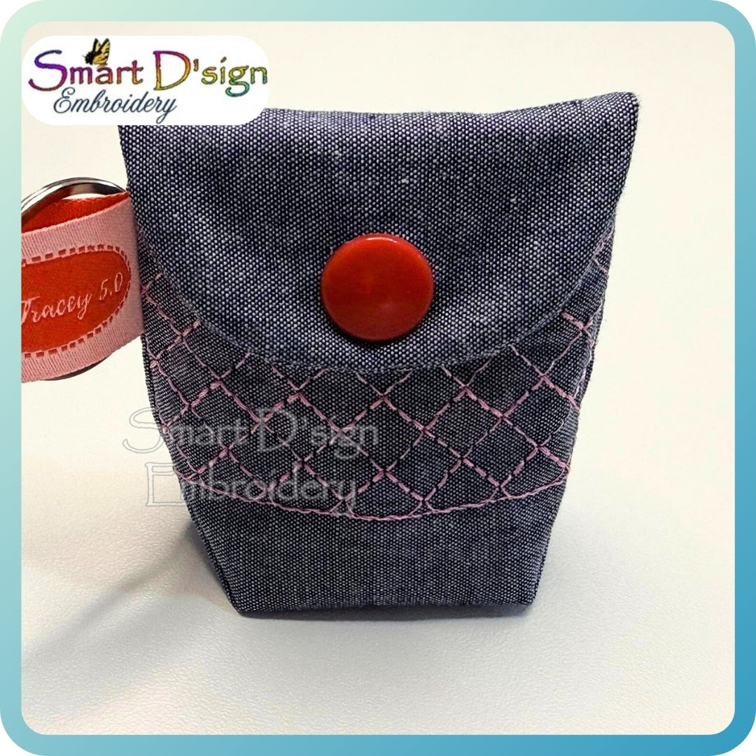 Fabric pouch with red button and 'Smart D'sign Embroidery' branding on a white background