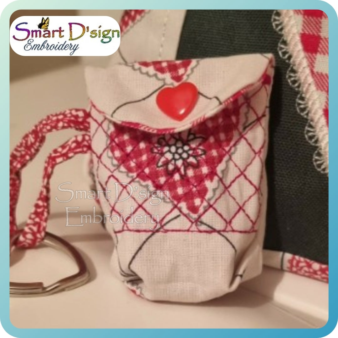 Embroidered pouch with heart design and plaid pattern, featuring Smart D'sign Embroidery logo.