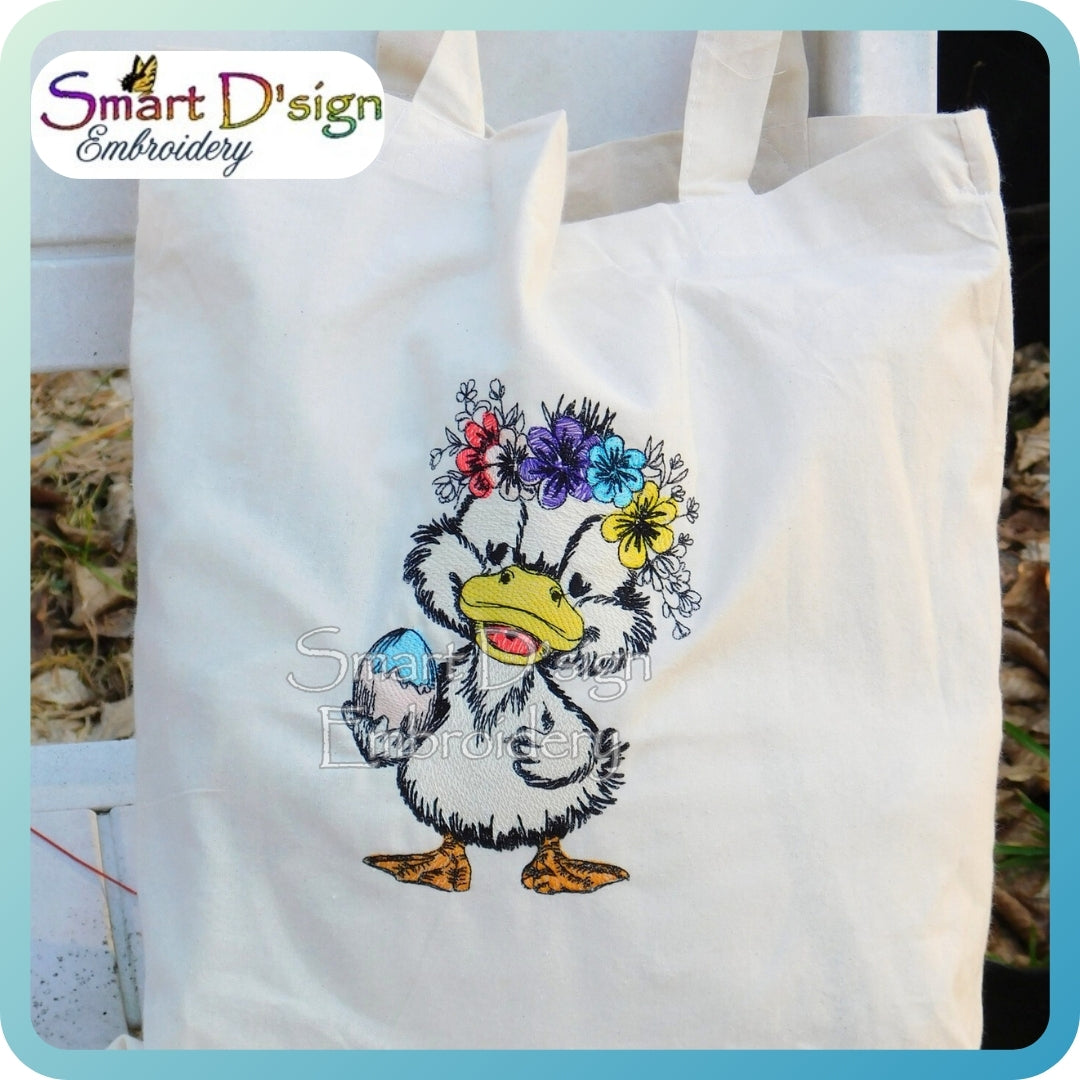 White tote bag with a duck wearing a floral headband design, branded 'Smart D'sign Embroidery'.
